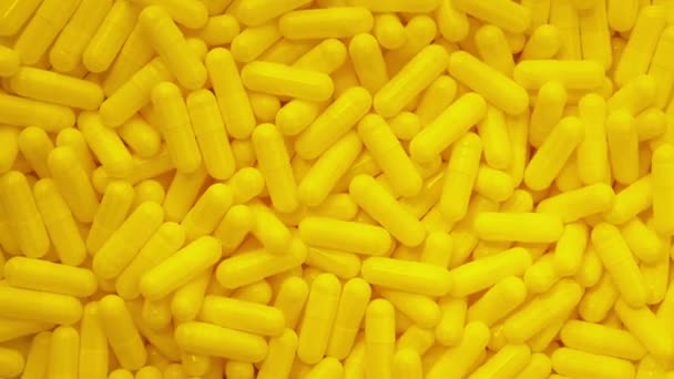 Yellow Health Capsules Rotating Overhead Shot — Stock Video
