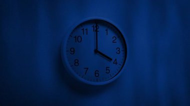 Wall Clock With Tree Shadows Moving Over It