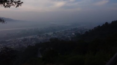 Ganga Nehri 'nin dağların ve köprünün önünden akması. Haridwar 'da gün batımında çekilen hacıların Tanrıça Ganga' ya dua ettiği ve ayinsel banyo yaptığı yerde..