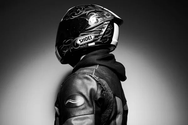 Handsome guy motorcyclist in helmet black white photo