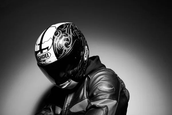 Handsome guy motorcyclist in helmet black white photo