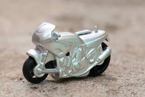 Small toy gray sports bike.