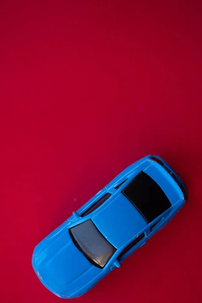 Φωτογραφία Ενός Αυτοκινήτου Παιχνιδιού Κόκκινο Φόντο — Φωτογραφία Αρχείου