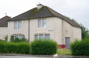 Derelict abandoned council house in poor housing crisis ghetto estate slum Paisley clipart