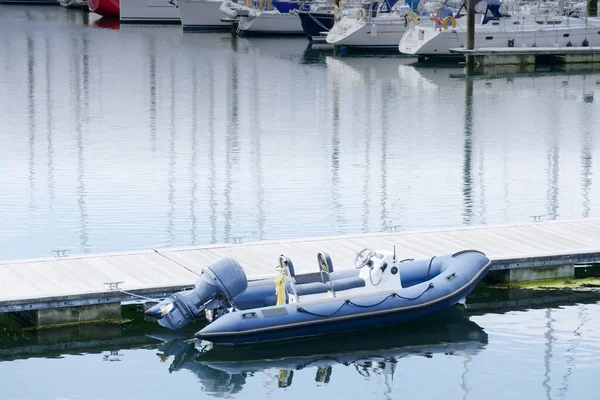 Inflatable dingy life rescue boat moored at marina — Stock Image Inflatable dingy life rescue boat moored at marina Royalty Free Stock Images