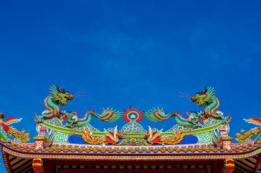 Ejderha kapısında iki ejderhanın güzel sanatı, Çin kültüründe. mavi gökyüzü arkaplanı.