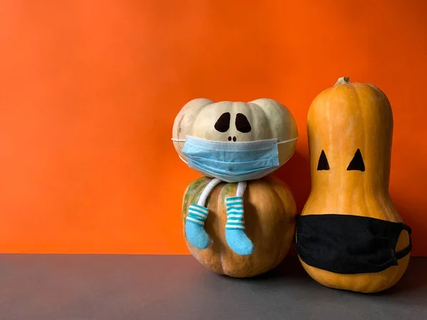 Creepy Halloween pumpkins with face masks in Coronavirus pandemic