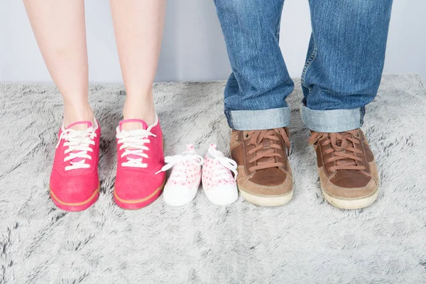 mother father and baby feet with shoes for family concept foot newborn girl