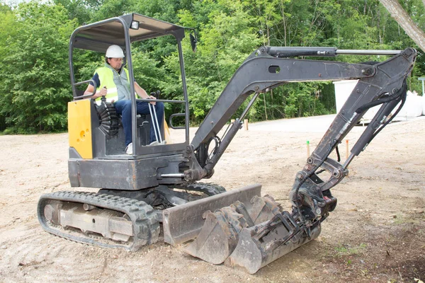 male operator man driver in excavator on construction site