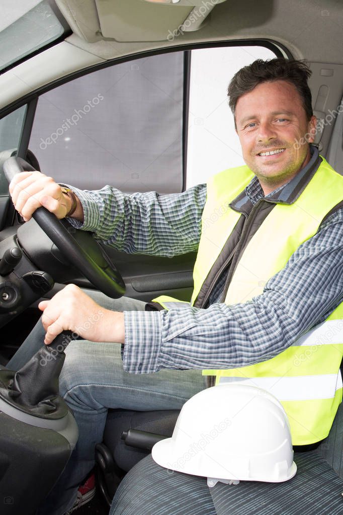 cheerful worker man smiling on van car on construction site
