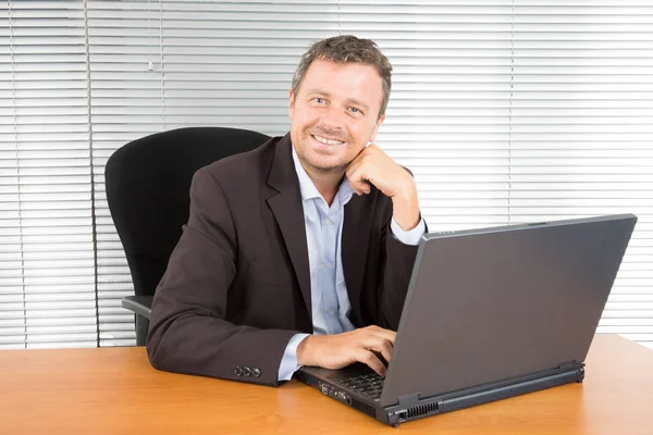 Šťastný Podnikatel Sedí Přední Části Notebooku — Stock fotografie