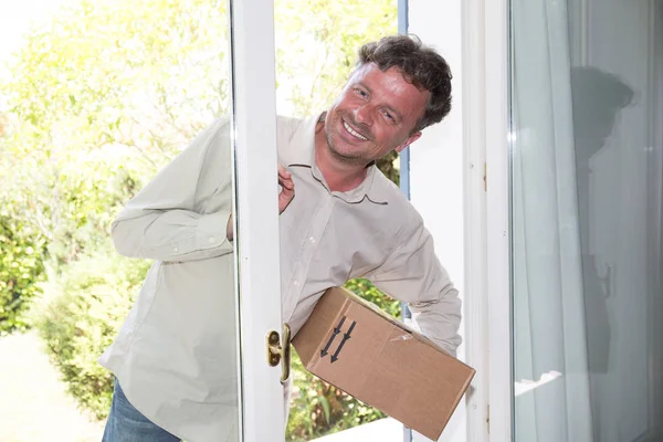 handsome man delivery guy deliver package at home house