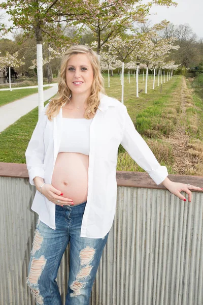 fashion blonde woman outdoor in pregnancy a pregnant concept with beauty girl