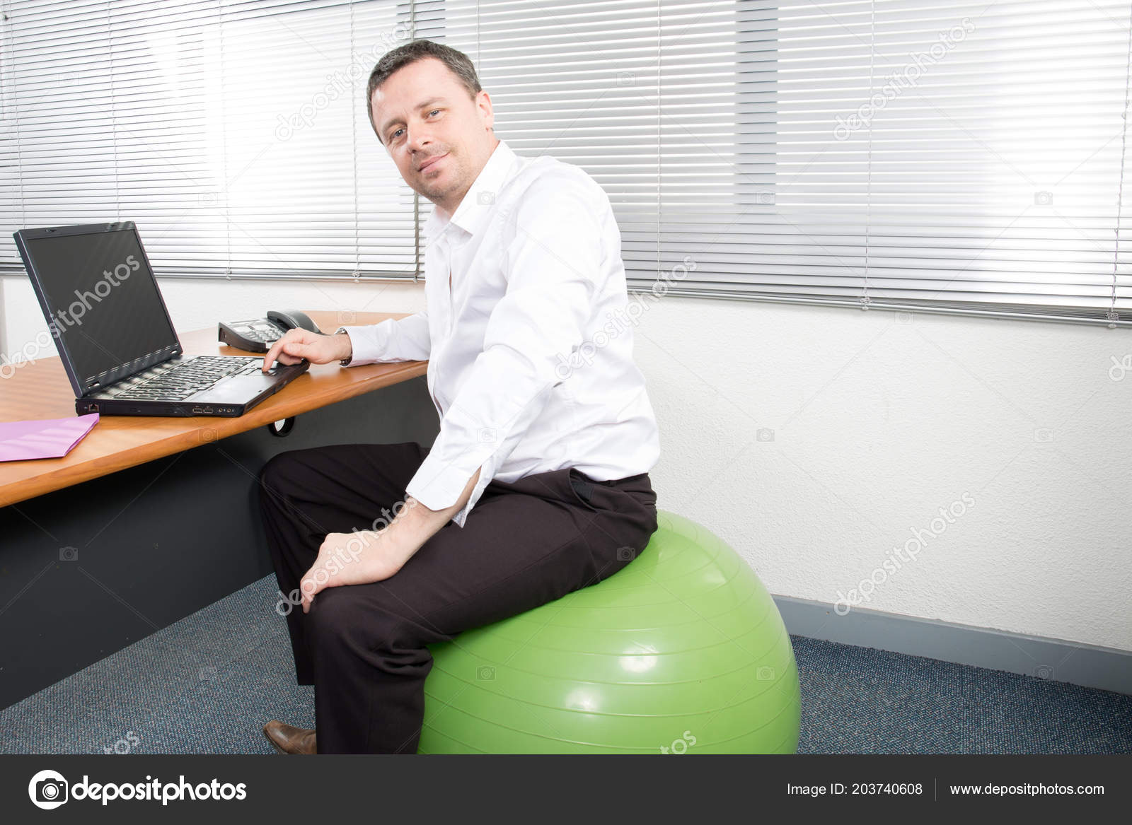 Smiling Businessman Sitting Exercise Balloon Desk Ball Seat Office