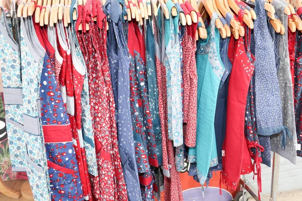 Clothes of different colors on vintage metal hanger in shop