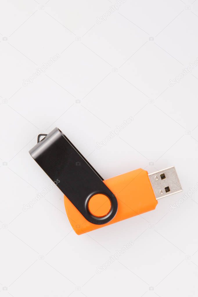 orange and steel usb flash drive in gray background