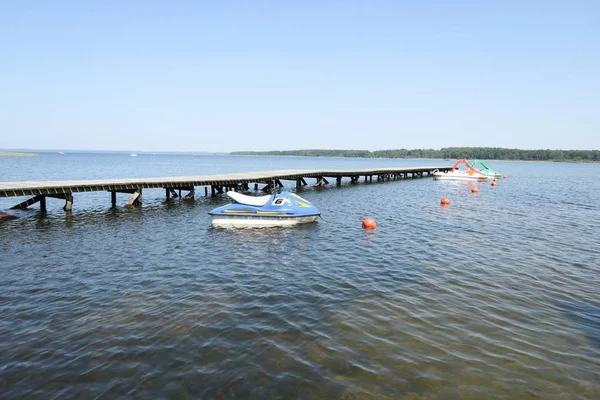pier pontoon wood on sea side with jet ski for rent