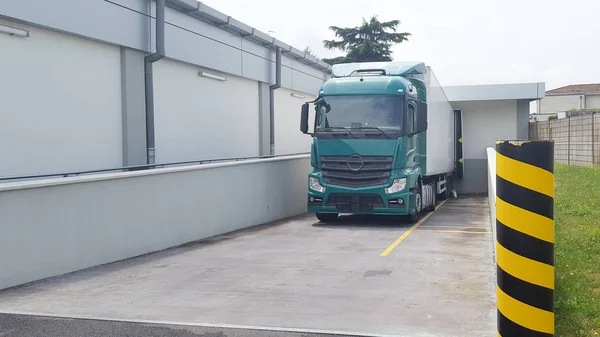 Truck semi trailers waiting unload at warehouse factory shop