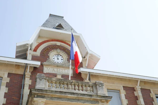 French flag waving over city hall in french country
