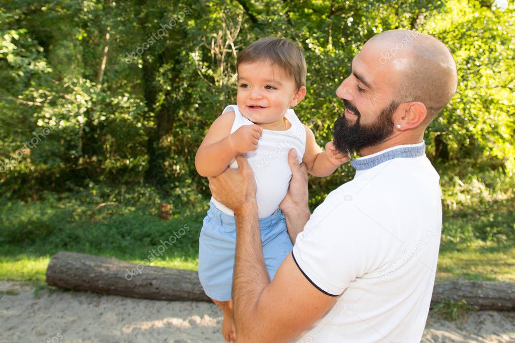 father Playing Game With son In Park