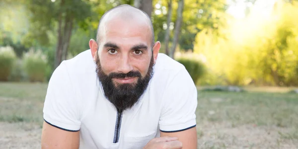 handsome bearded man lying on summer grass day