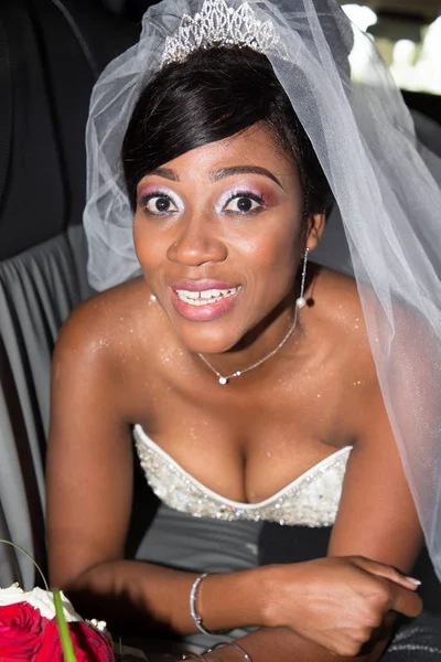 pretty african american black bride lying in limousine car of marriage