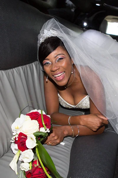 close-up portrait of a pretty black american bride in a car limousine in african wedding