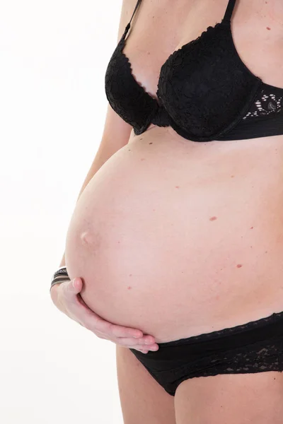白で隔離の手の腹で彼女の裸の腹部を受け入れる若い妊婦の側面図 — ストック写真