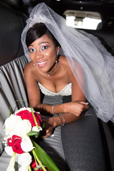 Portrait of an African American bride enjoying party in limousine car wedding