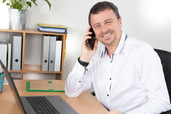 オフィスのデスクで電話をかけるプロのビジネスマン — ストック写真