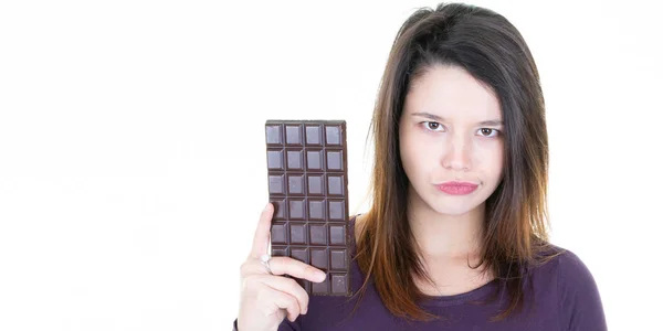 beautiful woman hesitates eating bar chocolatein white background