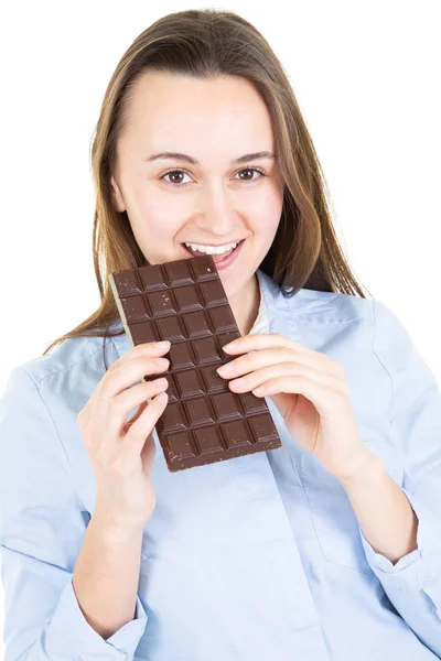 白人アダルト女性白い壁を食べる以上スマートの幸せそうな顔で自信を持って幸せな笑顔な表情でチョコレートバー — ストック写真