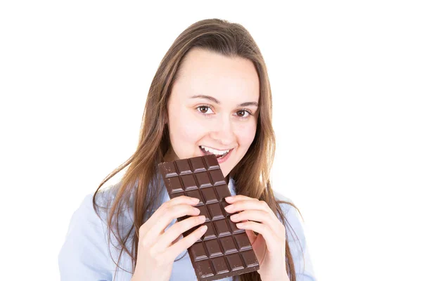 白い背景のチョコレート バーを食べる若い女性の肖像画 — ストック写真