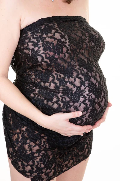 Jonge Vrouw Met Handen Haar Buik Tegen Een Witte Achtergrond — Stockfoto