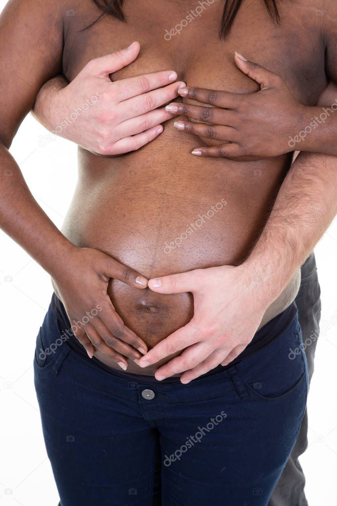 mixed loving Couple Embrace Arms Around Pregnant Belly black skin under white background