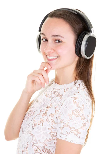 ファッションかなり甘いの屈託のない女の子は ヘッドフォンで音楽を聴く — ストック写真