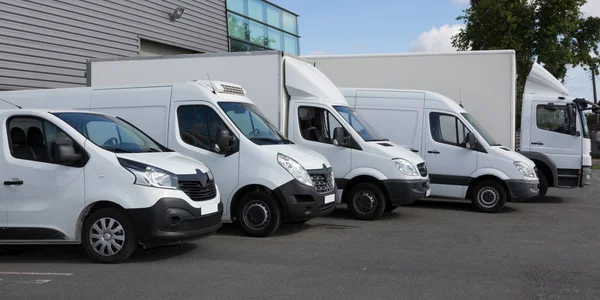 White Delivery Trucks Backed Up to A Warehouse Building — Stock Photo, Image