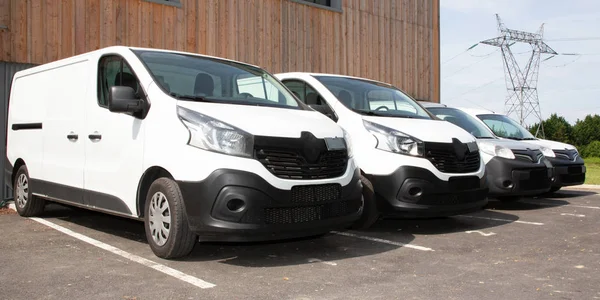 delivery van small trucks line up park outside