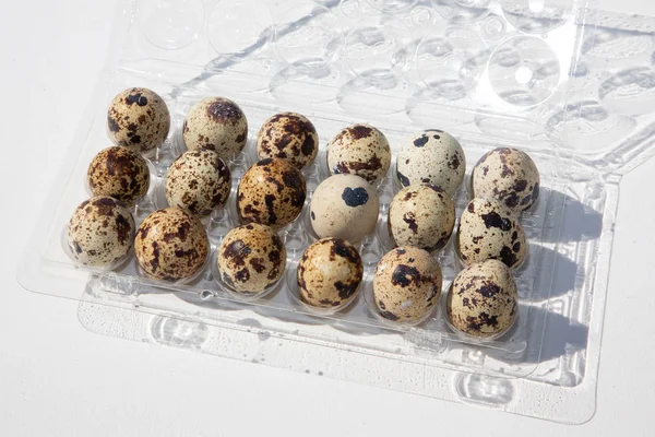 Quails Eggs Opened Pack Plastic White Background — Stock Photo, Image