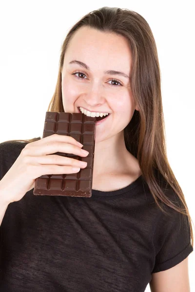 バーチョコレートを食べる若い幸せな女性の肖像画は カメラで見えます — ストック写真
