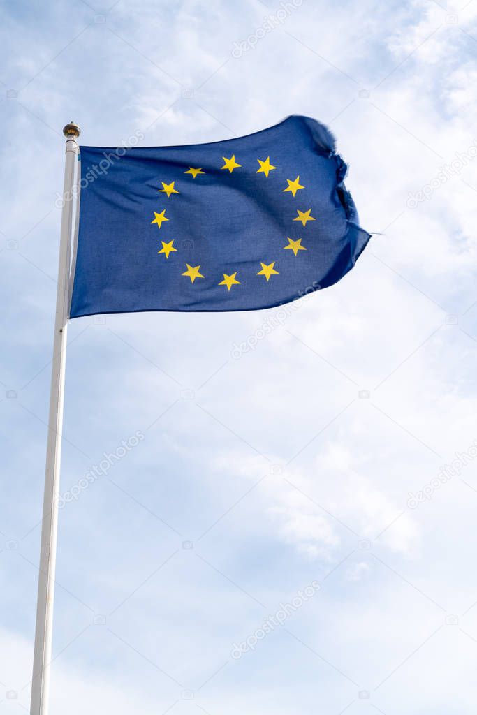 waving flag of European Union in cloudy sky in mat