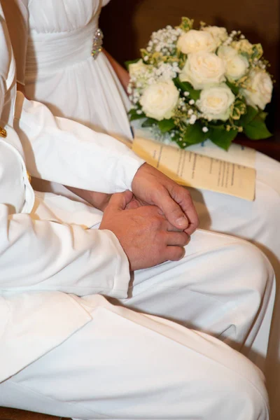 Hand of the groom and the bride in wedding church marriage