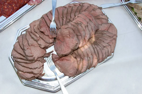 Cold roast beef dish on the table for guests