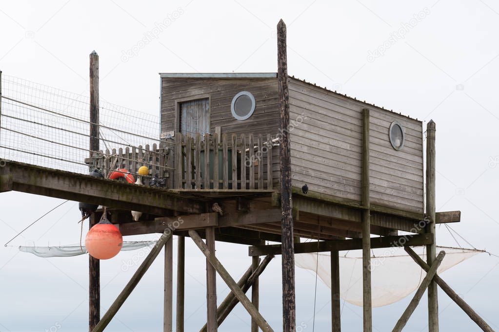 Typical wooden fishing huts on stilts in atlantic ocean near La Rochelle France