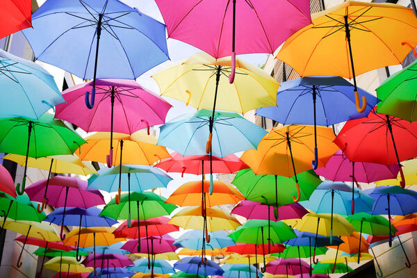 Colorful umbrellas multicolored rainbow hung over the street