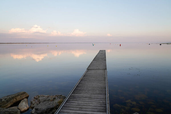 sunrise reflexion on fishing boat wooden pontoon in sunset Lake of sanguinet france
