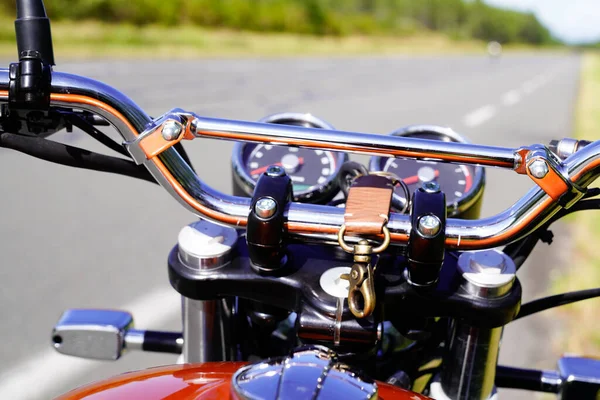 motorcycle handlebars of classic vintage motorbike along a road in the countryside