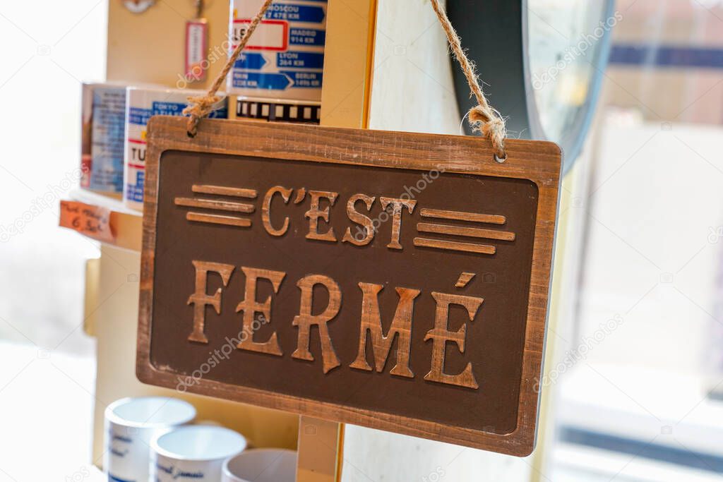 wooden sign shop panel write in french c'est ferme means store is closed now