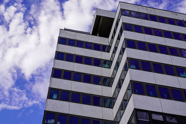 Modern business center building in blue cloud sky