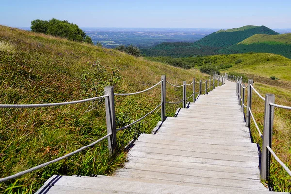 Stairs wood pathway of the Puy de Dome volcano mountain in mountain center of france